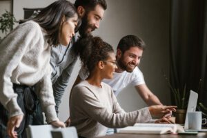 Professionals viewing something on a laptop
